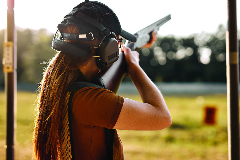 Young female on tactical gun training classes. Woman with weapon, rear view River Ridge-Shooting-Club-Our Range-Kasota MN